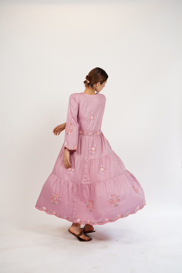 Back view of a lavender pink tiered maxi dress with embroidery details and a flattering waistline.