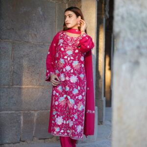 Full-length view of a magenta Aari-embroidered kurta paired with a matching churidar and chiffon dupatta.